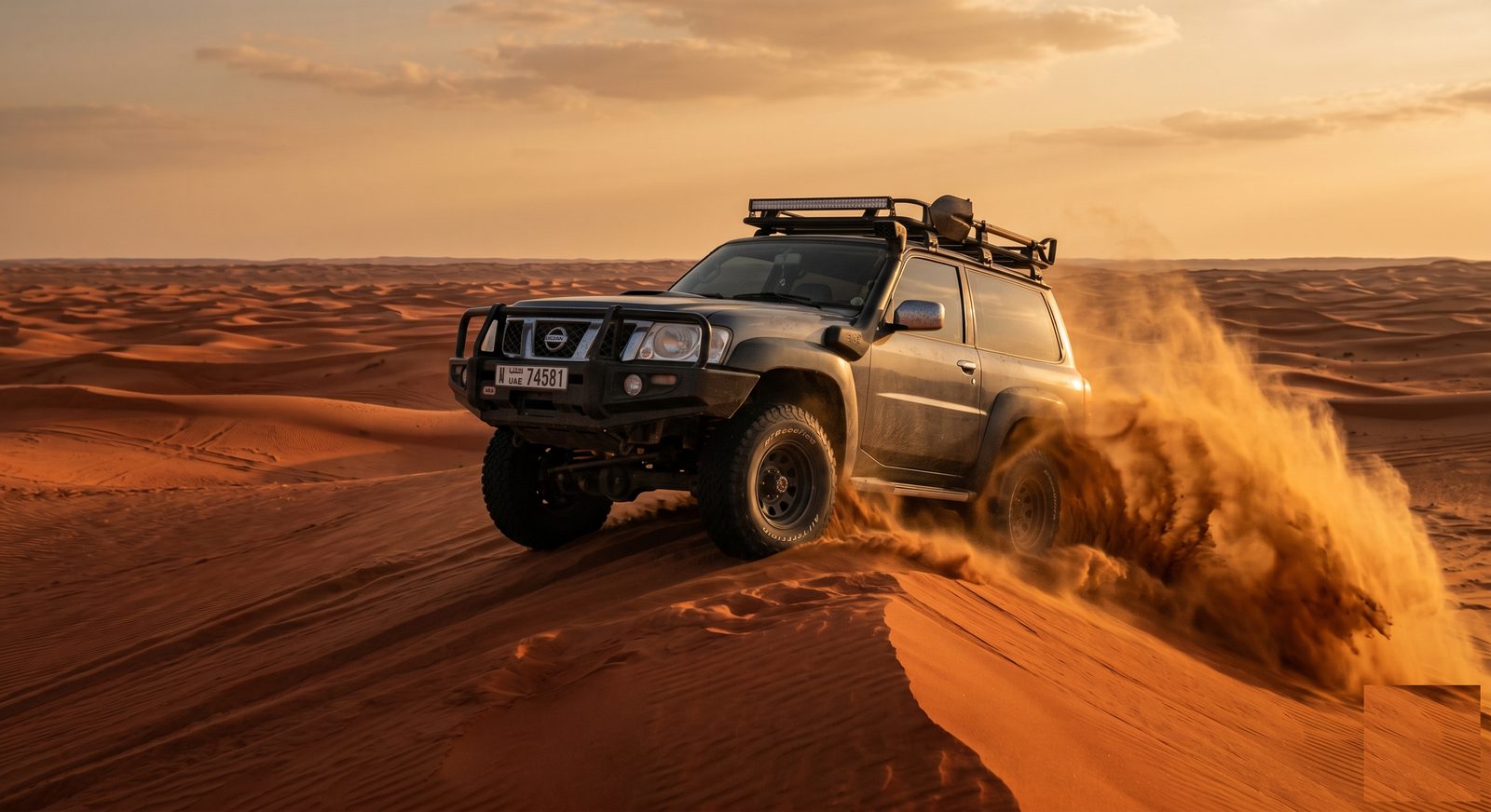 Nissan Patrol Y61 dune bashing in the UAE desert at golden hour